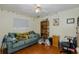 Bedroom featuring wood floors, and a couch with NFL décor at 512 Winding Willow Dr, Palm Harbor, FL 34683