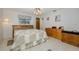 Comfortable bedroom featuring a bed, wooden dresser, and tile flooring at 512 Winding Willow Dr, Palm Harbor, FL 34683