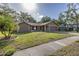 Charming single-story home featuring a well-manicured lawn, stone accents, and a two-car garage at 512 Winding Willow Dr, Palm Harbor, FL 34683