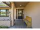 Inviting front entrance with a tiled porch, bench, and well-lit doorway at 512 Winding Willow Dr, Palm Harbor, FL 34683
