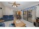 Spacious living room with tile flooring, ceiling fan and access to the kitchen at 512 Winding Willow Dr, Palm Harbor, FL 34683