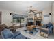 Cozy living room with stone fireplace, tile flooring and a view of the pool at 512 Winding Willow Dr, Palm Harbor, FL 34683