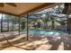 Covered pool with a screen enclosure offers relaxation and outdoor enjoyment at 512 Winding Willow Dr, Palm Harbor, FL 34683