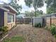 Spacious backyard with a wooden fence and storage shed, offering privacy and functionality at 5406 Dartmouth Rd, New Port Richey, FL 34652
