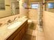 Well-lit bathroom with a granite vanity top and a shower-tub combination at 5406 Dartmouth Rd, New Port Richey, FL 34652