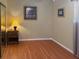 Simple bedroom with wood floors, neutral walls, and mirrored closet at 5406 Dartmouth Rd, New Port Richey, FL 34652