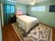 Relaxing bedroom with an area rug, a large bed, and side tables at 5406 Dartmouth Rd, New Port Richey, FL 34652