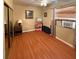 Modest bedroom featuring wood floors, blind-covered windows, and an air conditioning unit at 5406 Dartmouth Rd, New Port Richey, FL 34652
