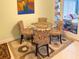 Cozy dining area with round glass table and decorative chairs next to the living room at 5406 Dartmouth Rd, New Port Richey, FL 34652