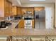 Spacious kitchen featuring wooden cabinets, stainless steel appliances, and granite countertops at 5406 Dartmouth Rd, New Port Richey, FL 34652