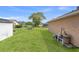 Spacious backyard with green grass and some fencing, great for outdoor activities and relaxation at 5411 Wellfield Rd, New Port Richey, FL 34655