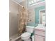 Full bathroom with shower and tub combination, featuring patterned shower curtain and neutral color scheme at 5411 Wellfield Rd, New Port Richey, FL 34655