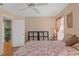 Bedroom featuring a queen-sized bed, natural light, and a storage unit with a door leading to another room at 5411 Wellfield Rd, New Port Richey, FL 34655