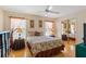 Cozy bedroom featuring a queen-sized bed, mirrored closet doors, and decorative curtains that allow natural light in at 5411 Wellfield Rd, New Port Richey, FL 34655