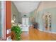 Welcoming entryway with an eye-catching plant and beautiful hardwood flooring and furnishings at 5411 Wellfield Rd, New Port Richey, FL 34655