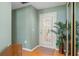 Entryway boasts a tiled floor, complemented by a potted plant and a white-framed glass door at 5411 Wellfield Rd, New Port Richey, FL 34655