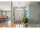 Welcoming entryway with a decorative front door, chandelier, and open view to the dining area at 5411 Wellfield Rd, New Port Richey, FL 34655