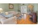 Cozy living room with hardwood floors, neutral paint and bright, natural lighting at 5411 Wellfield Rd, New Port Richey, FL 34655