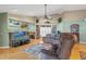 Bright living room with a fireplace, built-in bookshelves, and comfortable seating furniture at 5411 Wellfield Rd, New Port Richey, FL 34655
