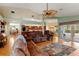 Open-concept living room with hardwood floors and access to the screened-in pool at 5411 Wellfield Rd, New Port Richey, FL 34655