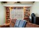 Inviting living area features a built-in bookcase and cozy chair, perfect for reading and relaxing at 5411 Wellfield Rd, New Port Richey, FL 34655