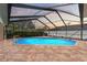 Sparkling pool with screened enclosure and patio, creating a private backyard oasis at 5411 Wellfield Rd, New Port Richey, FL 34655
