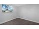 Comfortable bedroom with soft carpet, fresh paint, and a sunlit window at 5651 Townhouse Dr # 5651, New Port Richey, FL 34652