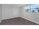 Cozy bedroom with neutral carpet, fresh paint, and a bright window at 5651 Townhouse Dr # 5651, New Port Richey, FL 34652