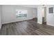 Spacious living area featuring modern flooring, neutral paint, and a bright window at 5651 Townhouse Dr # 5651, New Port Richey, FL 34652
