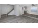 Open floor plan featuring modern flooring, fresh paint, stairs, and an updated kitchen at 5651 Townhouse Dr # 5651, New Port Richey, FL 34652