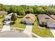 Aerial view of house with well-manicured lawn, trees, and driveway at 5676 Legend Hills Ln, Spring Hill, FL 34609
