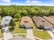 Aerial view of a well-kept home with green lawn and trees at 5676 Legend Hills Ln, Spring Hill, FL 34609