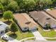 Aerial view of the house showing a driveway and well-maintained lawn at 5676 Legend Hills Ln, Spring Hill, FL 34609
