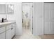 Neutral-toned bathroom with shower, toilet, and sink vanity, accessed through open doorway, adjacent to closet at 5676 Legend Hills Ln, Spring Hill, FL 34609