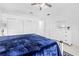 Spacious bedroom features a blue comforter, white furniture and an ensuite bathroom at 5676 Legend Hills Ln, Spring Hill, FL 34609
