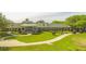 Beautiful clubhouse featuring manicured lawns and convenient golf cart parking at 5676 Legend Hills Ln, Spring Hill, FL 34609