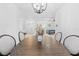 Elegant dining room with chandelier and views to entry and living room at 5676 Legend Hills Ln, Spring Hill, FL 34609