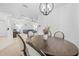 Dining room adjacent to the living room with a modern chandelier and comfortable seating for Gathering gatherings at 5676 Legend Hills Ln, Spring Hill, FL 34609