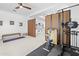 Open exercise area with a weight machine and elliptical trainer viewed through dividing doors at 5676 Legend Hills Ln, Spring Hill, FL 34609
