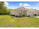 Charming single-story home with well-manicured lawn and lush landscaping at 5676 Legend Hills Ln, Spring Hill, FL 34609