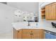 Modern kitchen with white countertops and wood cabinetry at 5676 Legend Hills Ln, Spring Hill, FL 34609