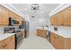 Spacious kitchen with stainless steel appliances and tile floors at 5676 Legend Hills Ln, Spring Hill, FL 34609