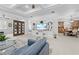 Living area showcasing seamless transition to dining space, featuring built-in shelving and modern fixtures at 5676 Legend Hills Ln, Spring Hill, FL 34609