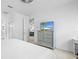 Bright main bedroom with gray dresser and a TV, with view to living room at 5676 Legend Hills Ln, Spring Hill, FL 34609