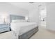 Beautiful main bedroom features blue furniture and a white comforter set at 5676 Legend Hills Ln, Spring Hill, FL 34609