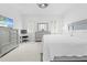 Bright main bedroom with a gray furniture set, plantation shutters, and a ceiling fan at 5676 Legend Hills Ln, Spring Hill, FL 34609