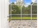 Screened patio features tile floors and a view of the green backyard at 5676 Legend Hills Ln, Spring Hill, FL 34609