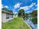 Backyard view with canal, dock, and reflection of blue skies and clouds in the water at 6045 Colony Cir, Weeki Wachee, FL 34607