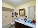 Bathroom features a shower-tub combination, a single sink vanity, and a mirror at 6045 Colony Cir, Weeki Wachee, FL 34607