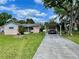 Exterior shot with a covered carport and an American flag on the property at 6045 Colony Cir, Weeki Wachee, FL 34607